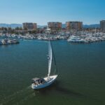white sail boat on ocean
