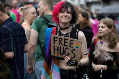 smiling woman with banner at parade