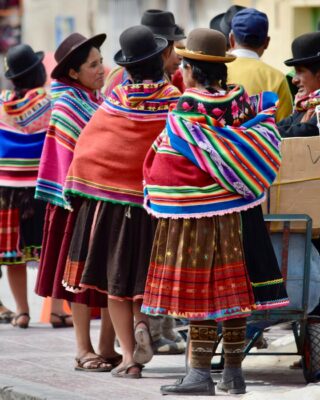 view of a group of people on a street wearing traditional folk costumes